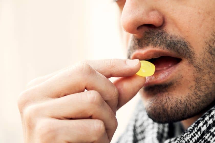 a man puts strepsils in his mouth