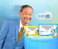 old man smiling near Strepsils products